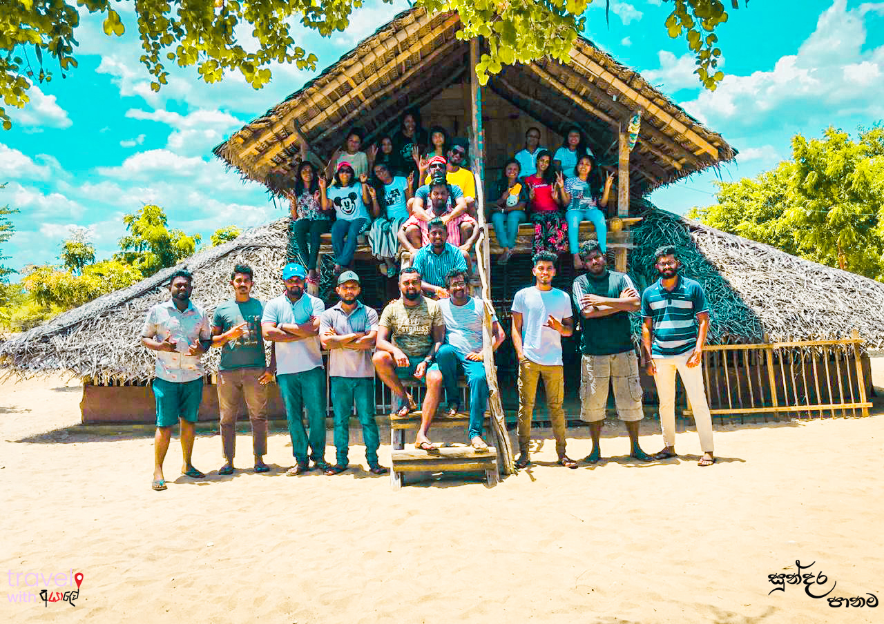 Group of friends infront of their unique shelter